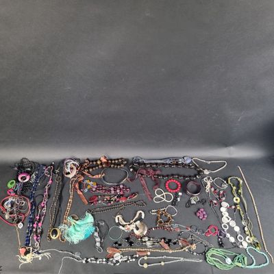 a lot of jewelry that is laying out on the table