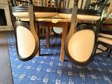chairs and a table in a room with a fireplace in the background