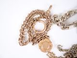 a gold chain with a locke and a chain with a key on it