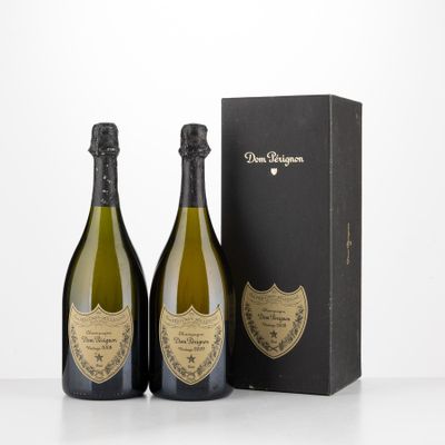 two bottles of champagne in front of a black box