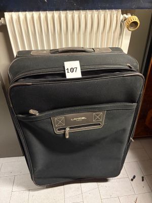 a piece of luggage sitting on the floor with a price tag on it