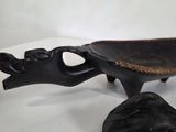 a black bowl with a handle on a white table