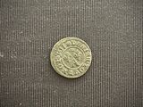 a small coin that is sitting on a black cloth