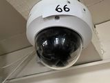 a surveillance camera mounted on the ceiling of a building