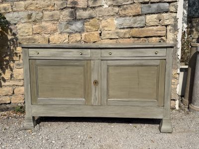 an image of a wooden cabinet sitting in front of a stone wall
