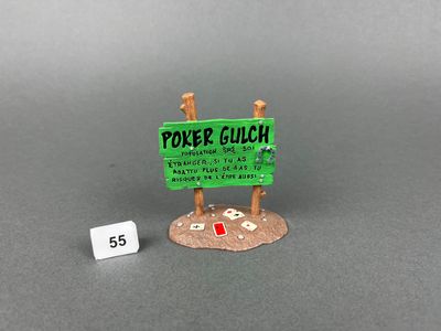 a small sign that is on the ground next to a dice