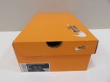 an orange nike shoe box sitting on top of a white table