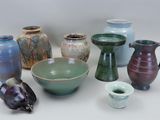 many different types of vases and bowls on the table