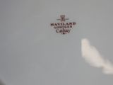 a white plate with a red and white logo on it