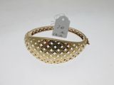 a close up of a gold bracelet with a price tag on it