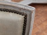 a close up of a chair with wood beads on the back