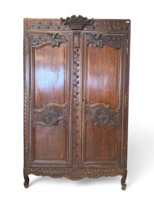 an old wooden armoire with carvings and carvings on the doors