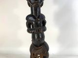 a wooden statue of a woman holding a baby