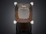 a close up of a ring with a large brown diamond