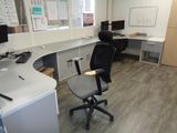 a desk with a chair and a computer on it