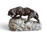 statue of a panther on a rock on a white background