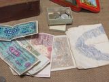 a box of money sitting on the floor next to a box of coins