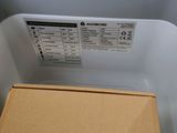 a box that is sitting on the floor next to a washing machine