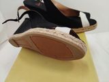 pair of black and white shoes on top of a yellow box