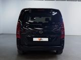 the back end of a black van parked in a garage