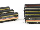 several model trains are lined up in a row on a white surface