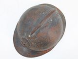 an old rusty helmet on a white surface
