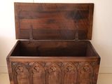 a wooden chest with carvings on it in a room