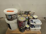many cans of paint and cans of paint on a pallet