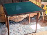 a small table with a green top in a room