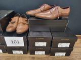 several boxes of shoes are stacked on top of each other on a wooden floor