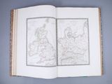 an open book with a map of europe on it on a blue surface