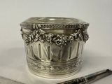 a silver cup and a knife on a table