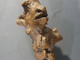 a wooden stick with a statue of a man on it