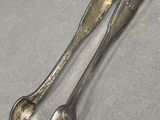 two spoons and a spoon rest on a table