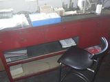 a red desk with a black chair in front of it