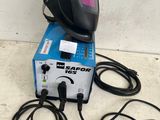 a welding machine sitting on top of a table next to some wires