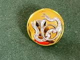 une broche en or et en argent ornée d'un dragon