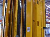 a large yellow fork lift truck in a warehouse