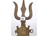 an old brass trinket with a large head and two horns on it