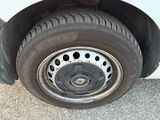 a close up of a tire on a white car