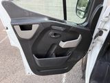 a door open of a white truck with a black seat belt