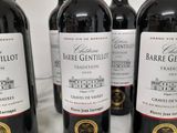four bottles of wine are lined up on a table