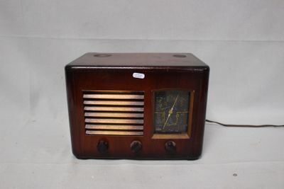 an old radio that is sitting on a white surface