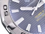 a close up of a watch with a blue dial