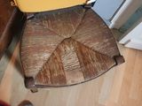 a yellow suitcase sitting on top of a wooden chair