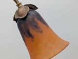 an old fashioned lamp on a pole against a gray sky