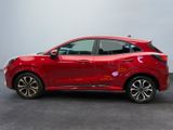 the red honda hrx is parked in a showroom