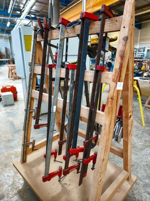 many tools on a wooden stand in a building
