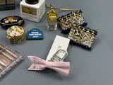 many items that are on a table with a pink bow tie
