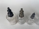 three glass bottles that are sitting next to each other
